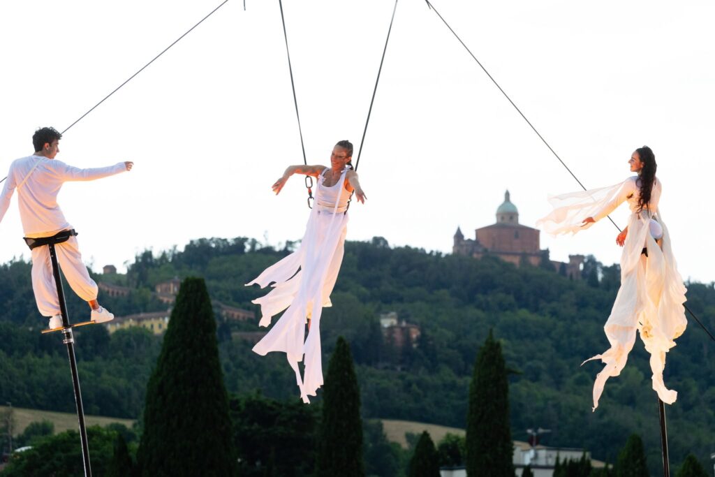 Two artists on sway poles and an artist on the hot-air balloon