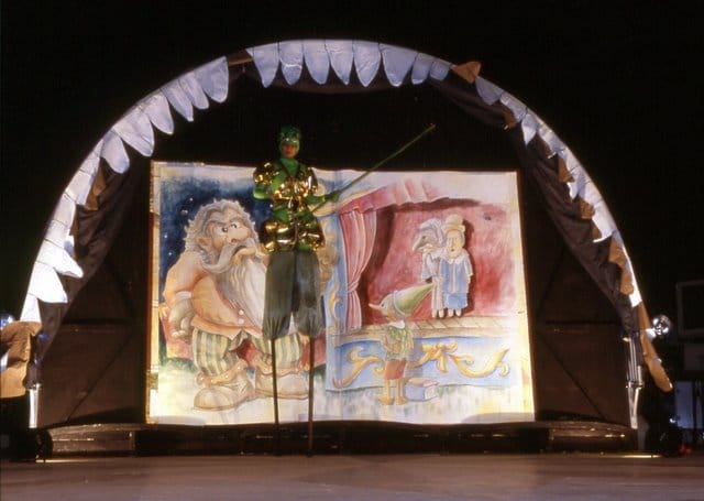 Talking Cricket in front of the book in the show Pinocchio on the Road