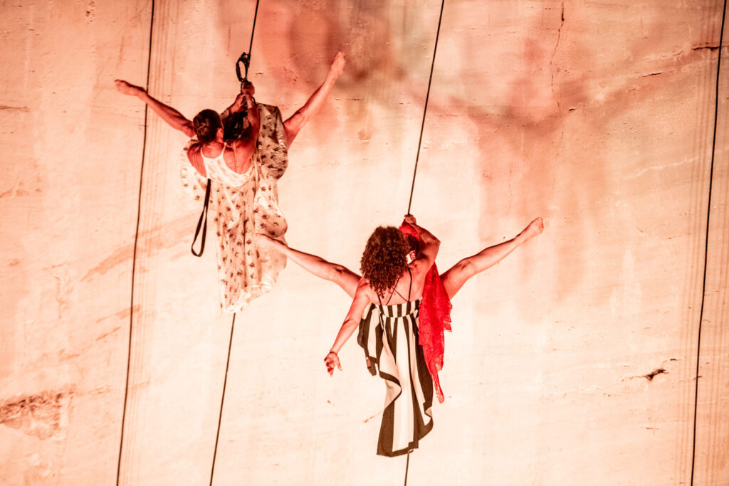 aerialists hanging vertical dance