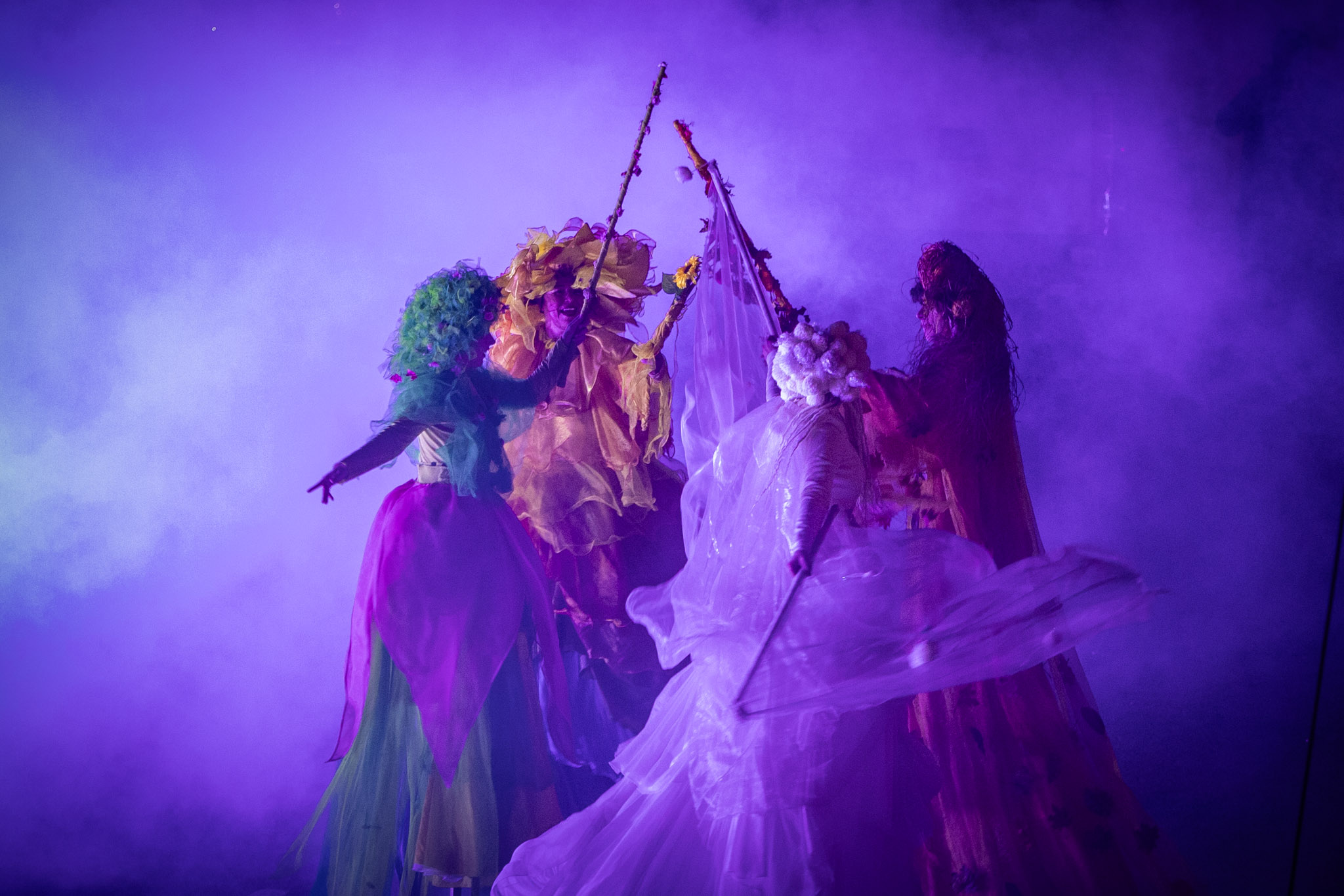 Trampolinists dressed as four seasons enveloped in smoke