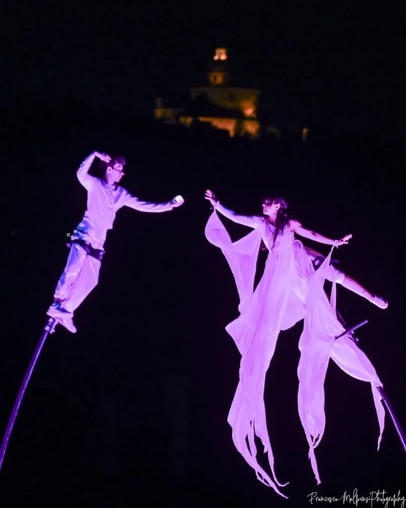 performers on sway poles during the Compagnia dei Folli show
