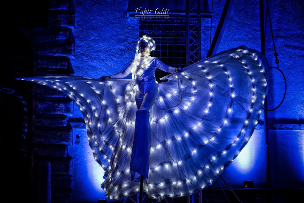 Luminous butterfly with open wings on stilts