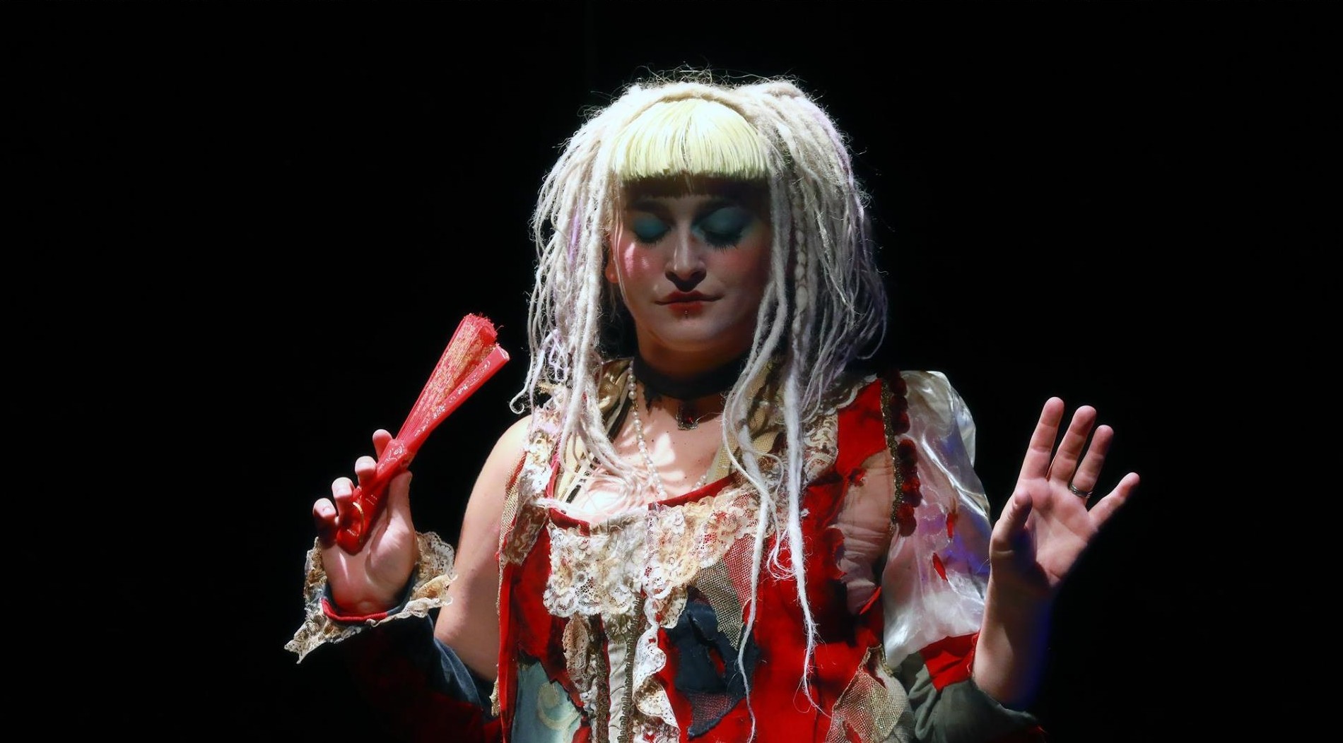 Artist from the Compagnia dei Folli in bizarre clothes and a white wig