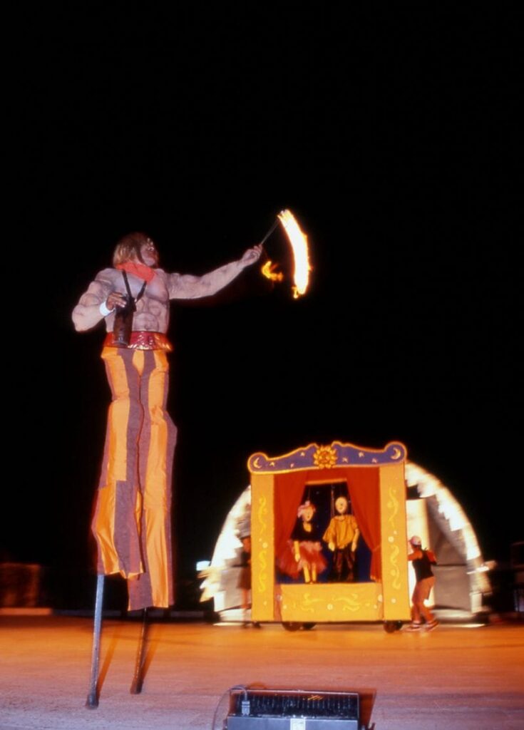 Fire-eater on stilts